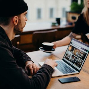 Freelancer working on a laptop in a cozy café setting. Ideal for remote work themes.